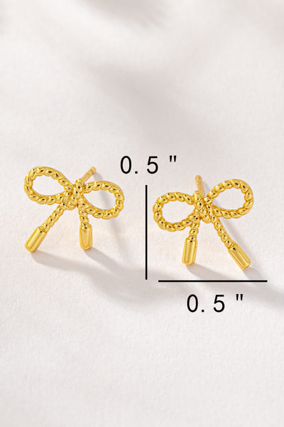 Small textured brass bow stud earrings